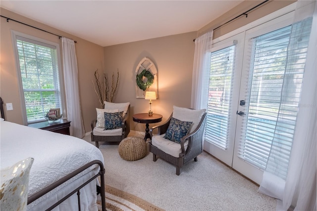 carpeted bedroom featuring french doors, access to outside, and multiple windows