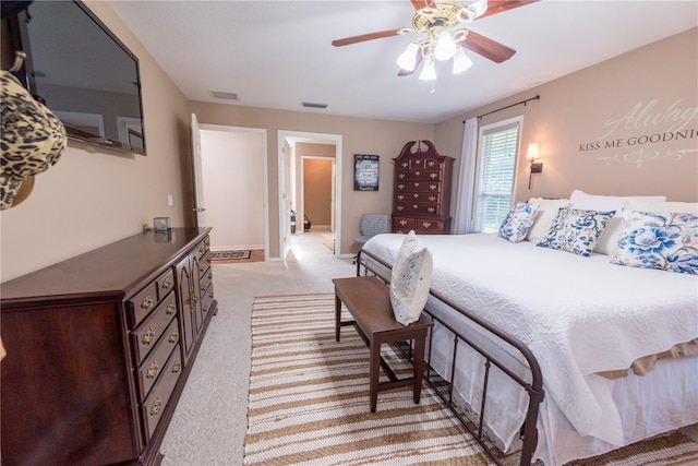 bedroom featuring light carpet and ceiling fan