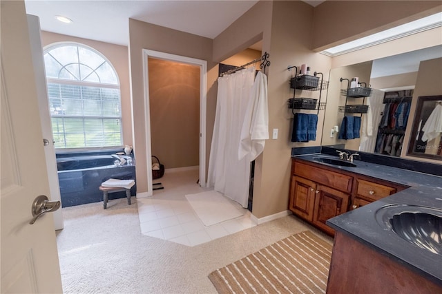 bathroom with tile patterned floors, vanity, and independent shower and bath