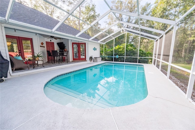 view of pool with french doors, a lanai, a patio area, and ceiling fan