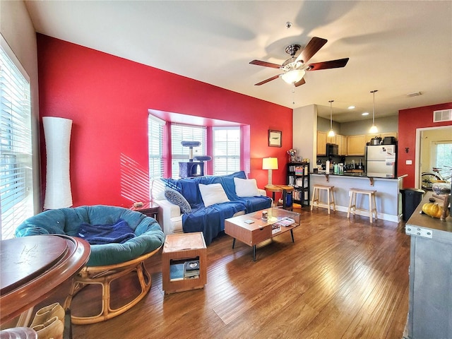 living room with ceiling fan, hardwood / wood-style floors, and a healthy amount of sunlight