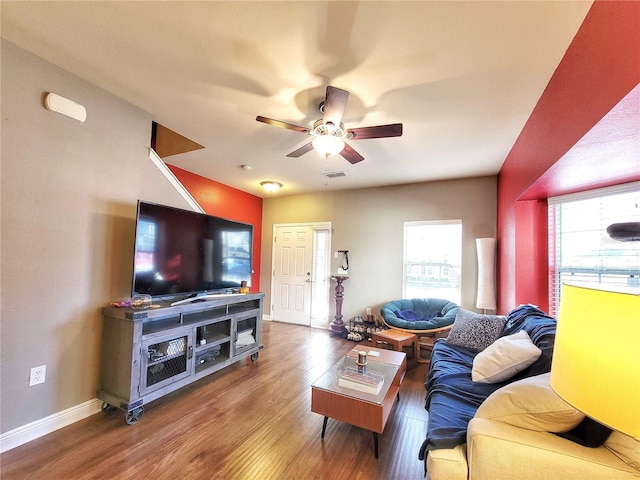 living room featuring ceiling fan, plenty of natural light, and hardwood / wood-style floors