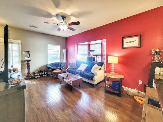 living room featuring wood-type flooring and ceiling fan