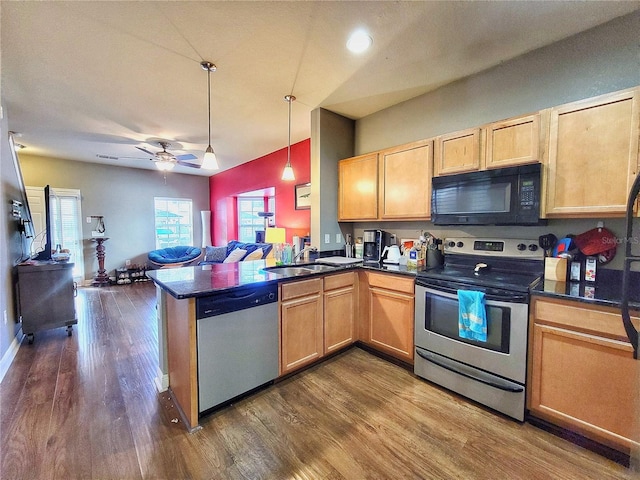 kitchen featuring ceiling fan, sink, dark hardwood / wood-style flooring, kitchen peninsula, and appliances with stainless steel finishes