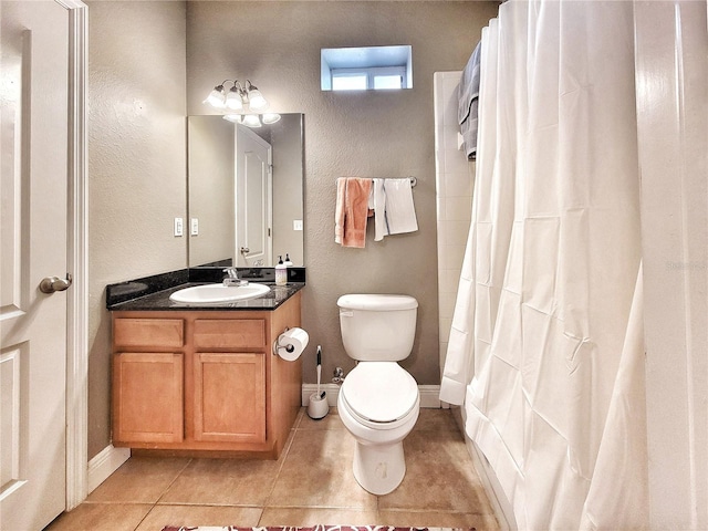 bathroom featuring tile patterned flooring, vanity, a shower with shower curtain, and toilet