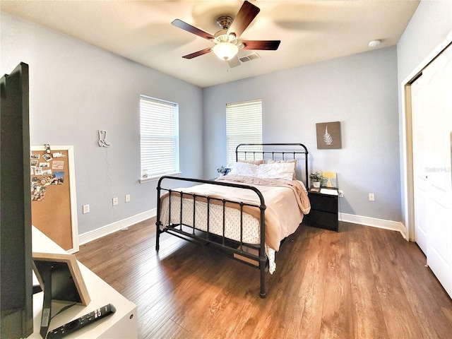 bedroom with hardwood / wood-style floors, a closet, and ceiling fan