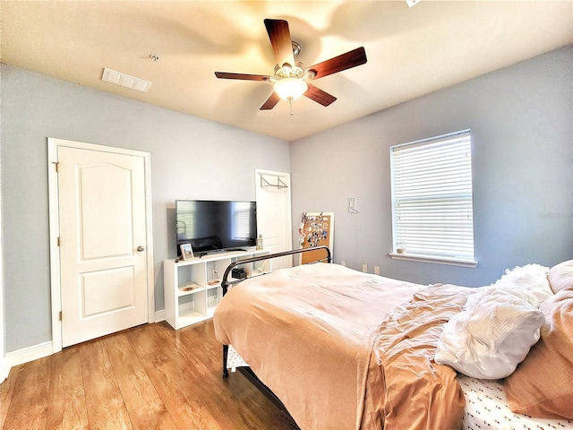 bedroom with ceiling fan and light wood-type flooring