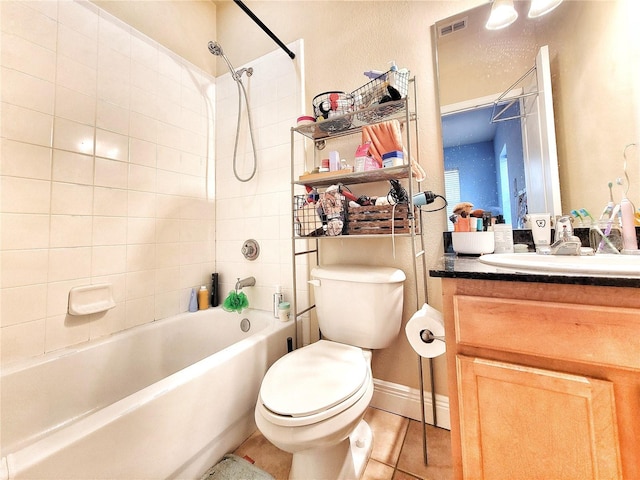 full bathroom featuring tile patterned flooring, vanity, toilet, and tiled shower / bath