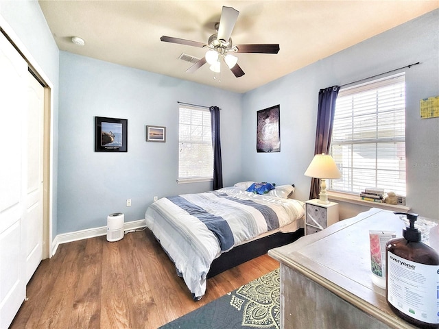 bedroom with ceiling fan, wood-type flooring, and a closet