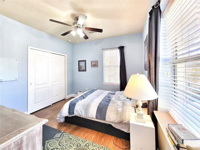 bedroom featuring hardwood / wood-style flooring, ceiling fan, and a closet