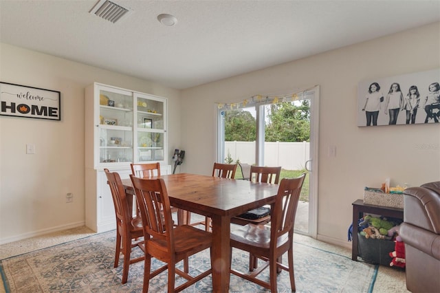 dining space with a textured ceiling