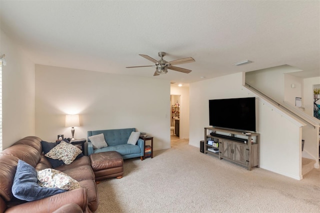 carpeted living room featuring a textured ceiling and ceiling fan