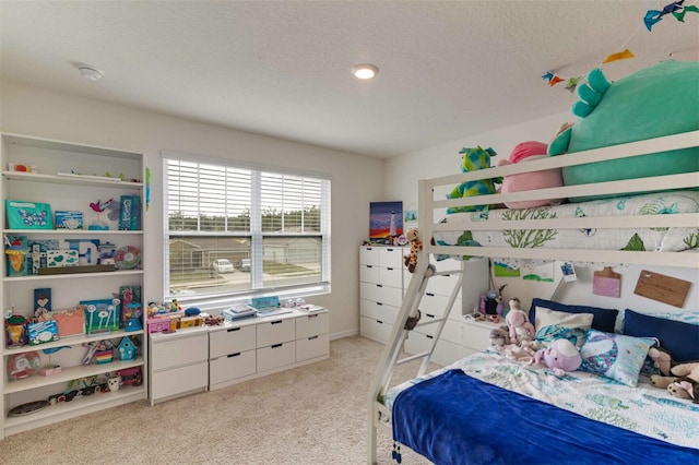 bedroom featuring light carpet and a textured ceiling