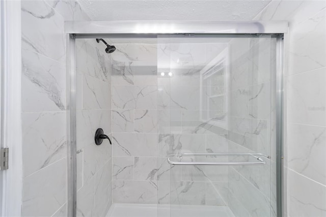 bathroom with a shower with shower door