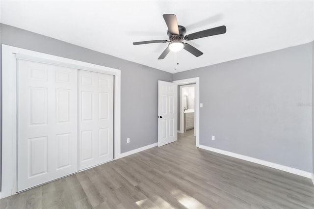 unfurnished bedroom featuring ceiling fan, a closet, and light hardwood / wood-style flooring