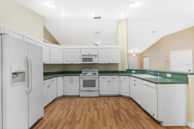 kitchen featuring white cabinets, white appliances, and vaulted ceiling