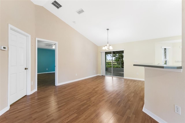 9573 SW 53rd Cir, Ocala, FL 34476 - unfurnished living room with wood finished floors, a chandelier, baseboards, and high vaulted ceiling