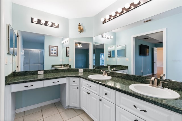 bathroom featuring tile patterned flooring, vanity, ceiling fan, and an enclosed shower