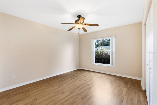 spare room featuring hardwood / wood-style floors and ceiling fan