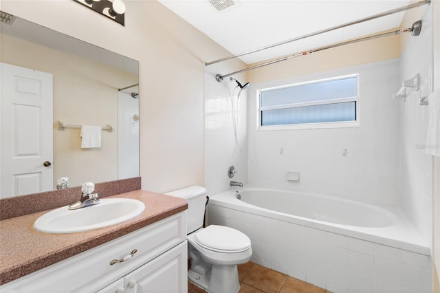 full bathroom with tile patterned floors, vanity, toilet, and tiled shower / bath combo