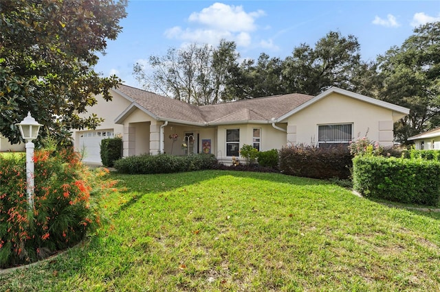 ranch-style house featuring a garage and a front lawn