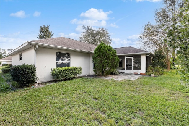 view of front of home featuring a sunroom and a front lawn