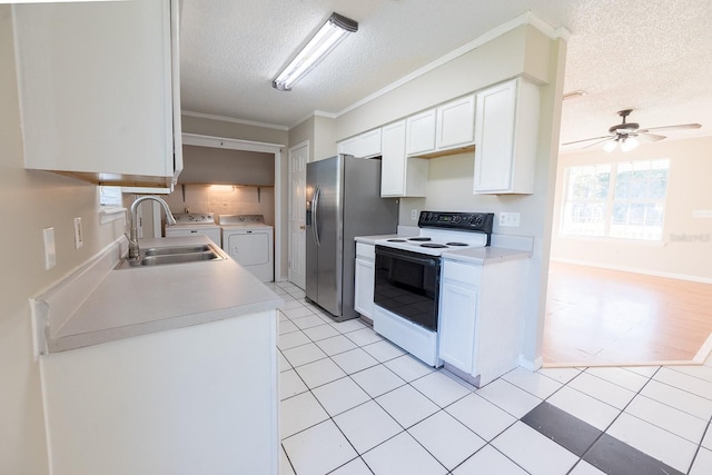 kitchen with sink, white electric stove, separate washer and dryer, a textured ceiling, and white cabinetry