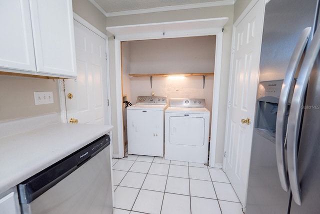 clothes washing area featuring washer and dryer, light tile patterned floors, and ornamental molding