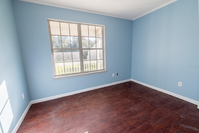 unfurnished room with dark hardwood / wood-style floors, ornamental molding, and a textured ceiling