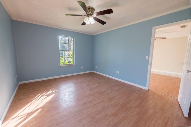 spare room featuring crown molding, ceiling fan, a textured ceiling, and light wood-type flooring