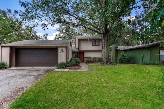 tri-level home with a garage and a front lawn