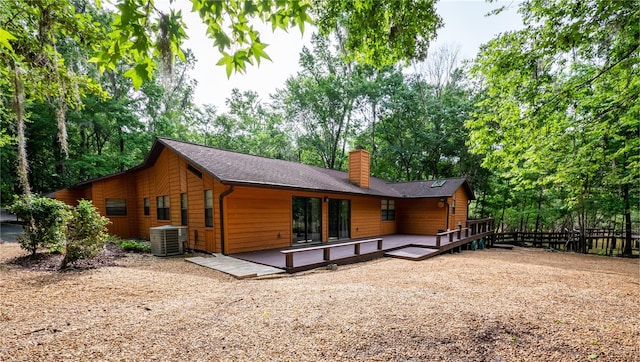 back of property featuring central air condition unit and a wooden deck