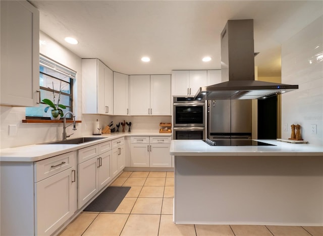 kitchen featuring island exhaust hood, stainless steel double oven, black electric cooktop, sink, and white cabinets