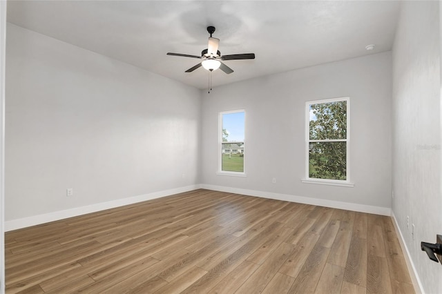 spare room with light hardwood / wood-style floors and ceiling fan