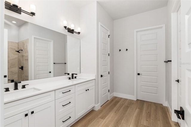 bathroom featuring a shower, vanity, and wood-type flooring