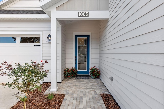 doorway to property with a garage