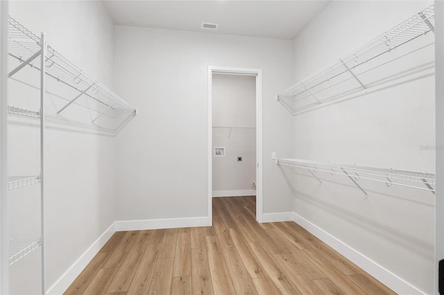 spacious closet featuring light wood-type flooring