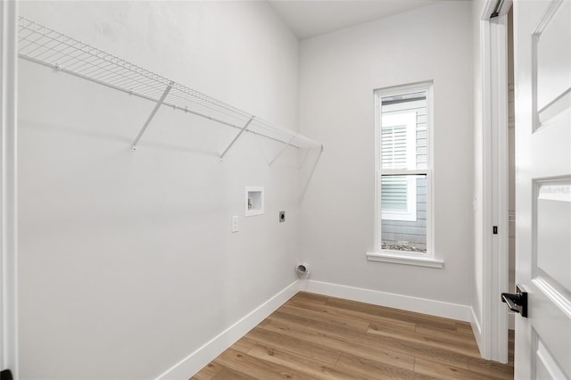 laundry room featuring hardwood / wood-style floors, electric dryer hookup, and washer hookup