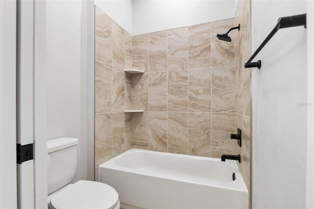 bathroom featuring tiled shower / bath combo and toilet