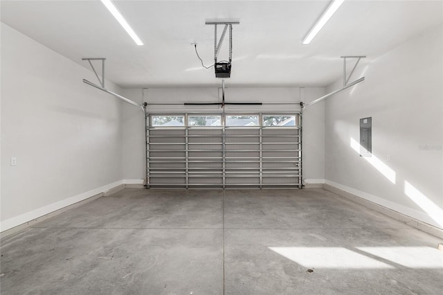 garage with a garage door opener and electric panel