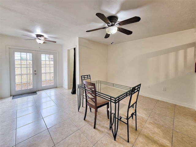 dining area with ceiling fan, light tile patterned floors, and french doors