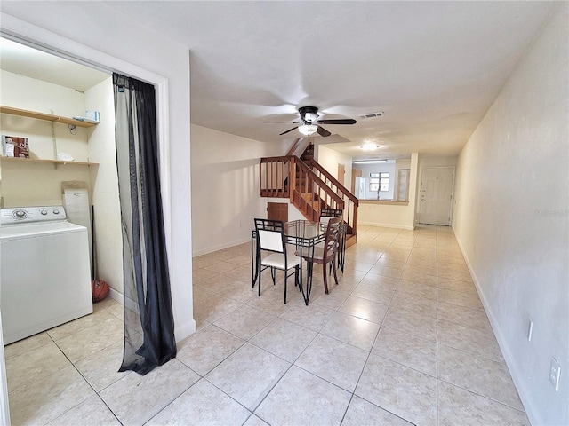 dining space featuring ceiling fan, light tile patterned flooring, and washer / dryer