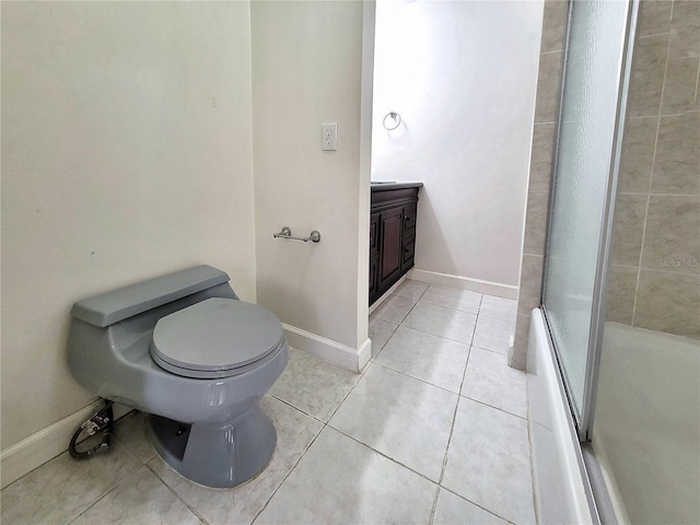 full bathroom with shower / bath combination with glass door, vanity, tile patterned floors, and toilet