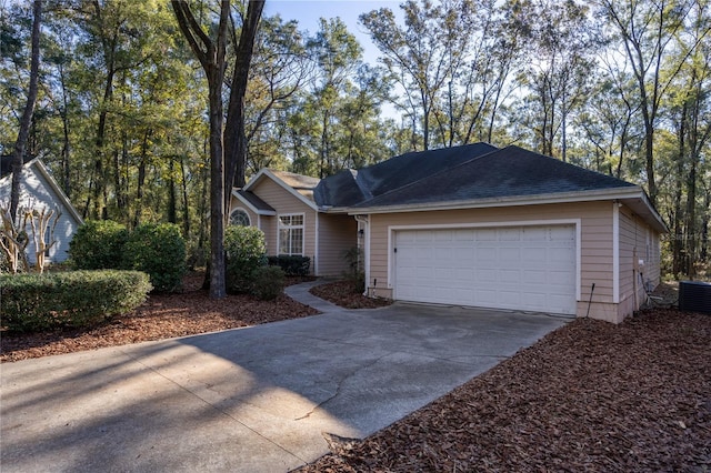 single story home with a garage and cooling unit