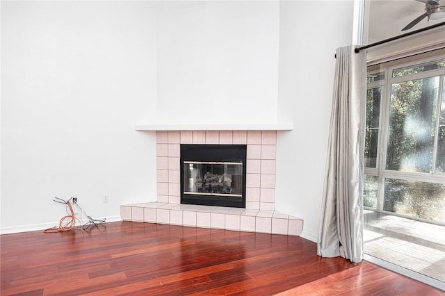 interior details with a fireplace, hardwood / wood-style flooring, and ceiling fan