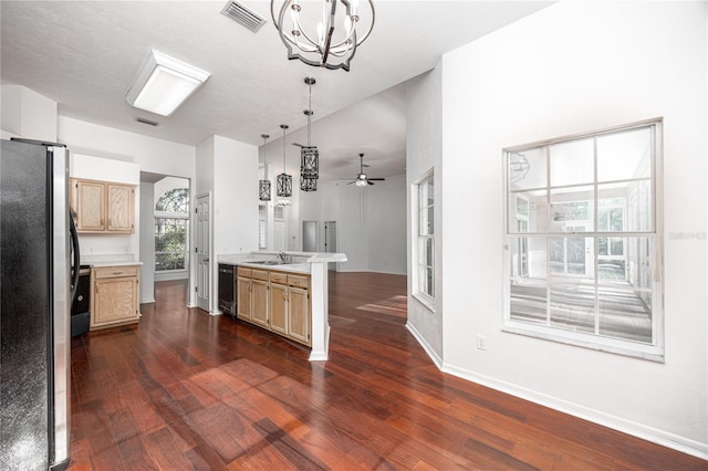 kitchen featuring kitchen peninsula, decorative light fixtures, stainless steel appliances, and dark hardwood / wood-style floors