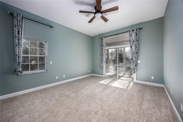 carpeted spare room with ceiling fan