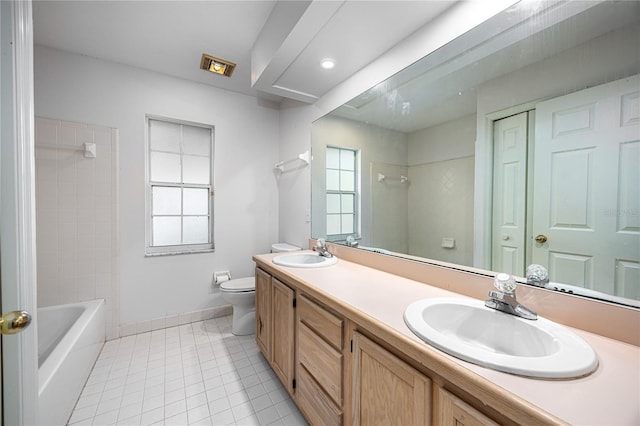 full bathroom with tile patterned floors, a wealth of natural light, vanity, and toilet