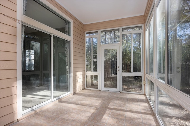 unfurnished sunroom featuring a healthy amount of sunlight