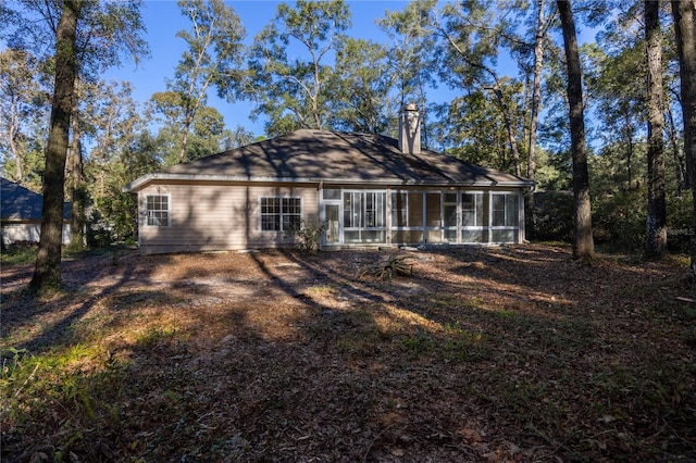 rear view of property with a sunroom